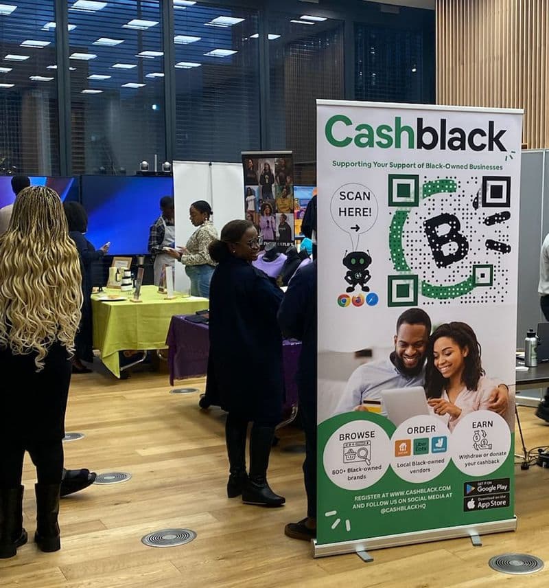 A CashBlack banner stand at an in-person marketplace event